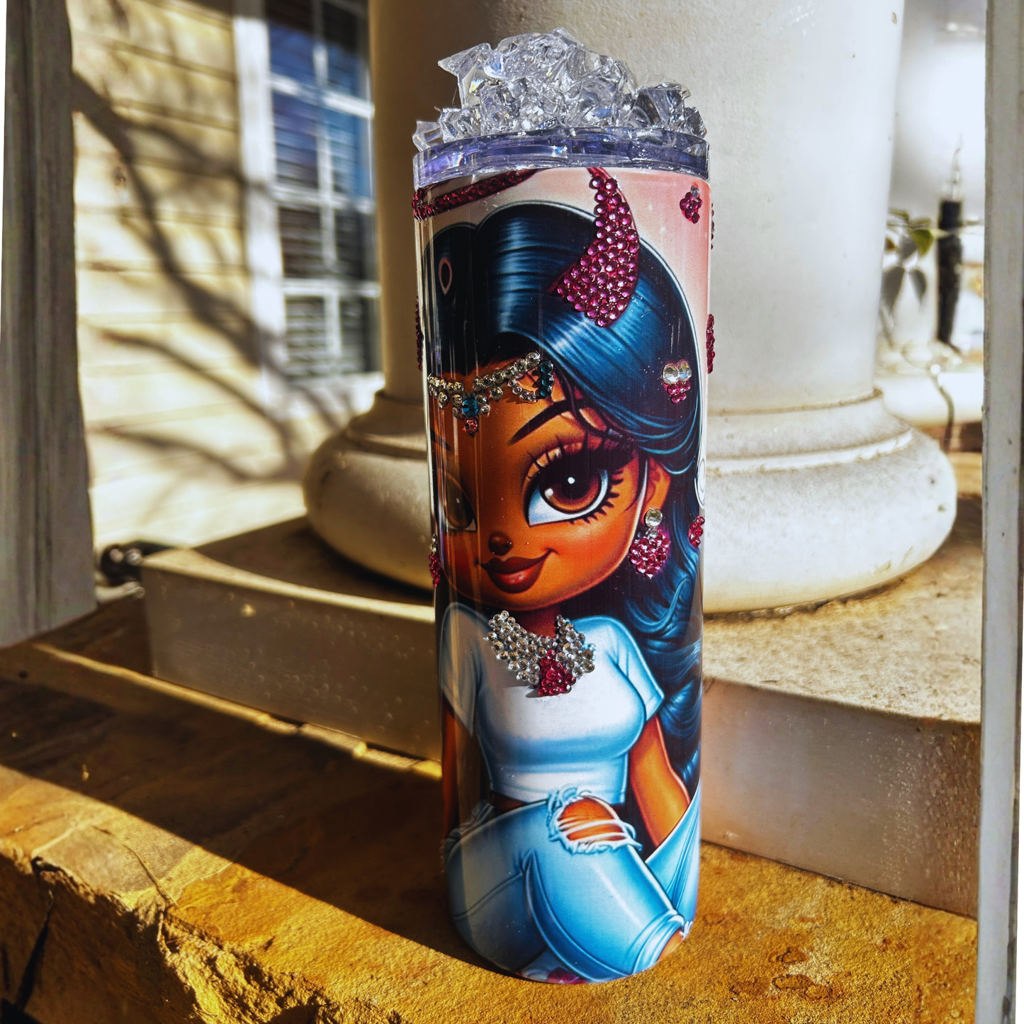Tumbler with a cartoon character design on a windowsill