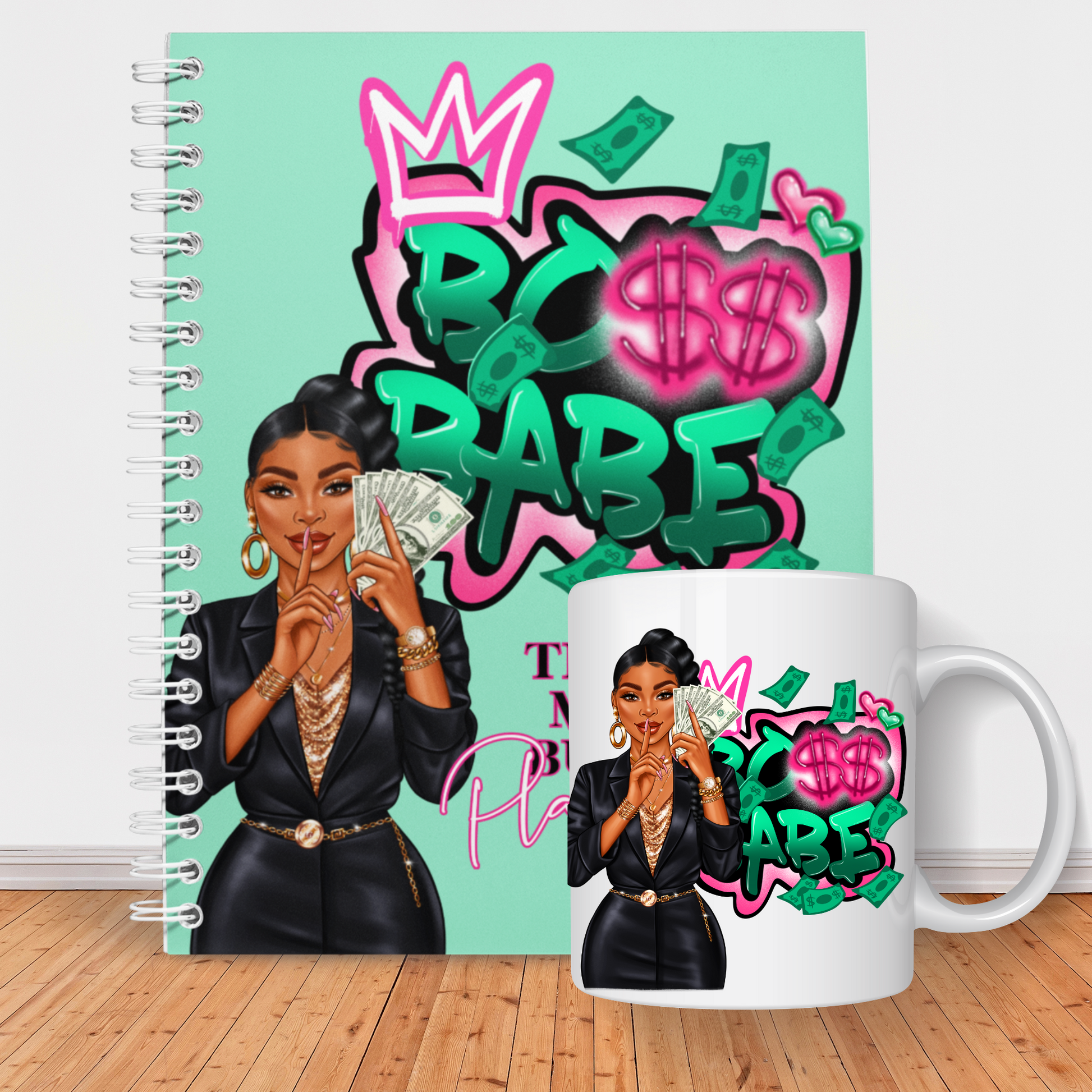  An African American woman in a black blazer and gold accessories silently gestures for quiet while holding cash. Behind her, the word "BABE" with a heart and dollar sign amidst floating bills, over the title "THE GET MONEY BUDGET PLANNER" against a mint green backdrop