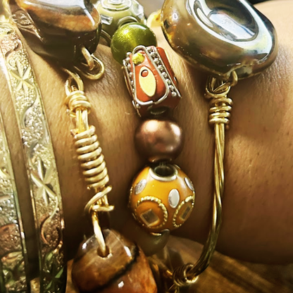 “Stack of handcrafted gemstone bracelets with gold wire wrap, earthy beads, and polished stones – boho spiritual jewelry”